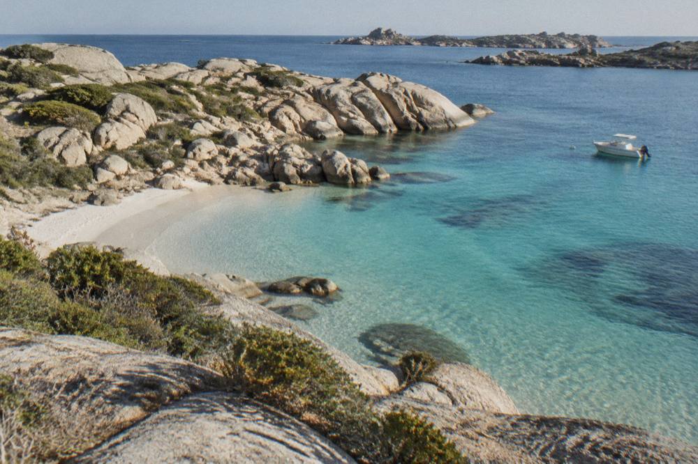 Granite rocks and pale sand on a small cove at the Lavezzi islands near Bonifacio