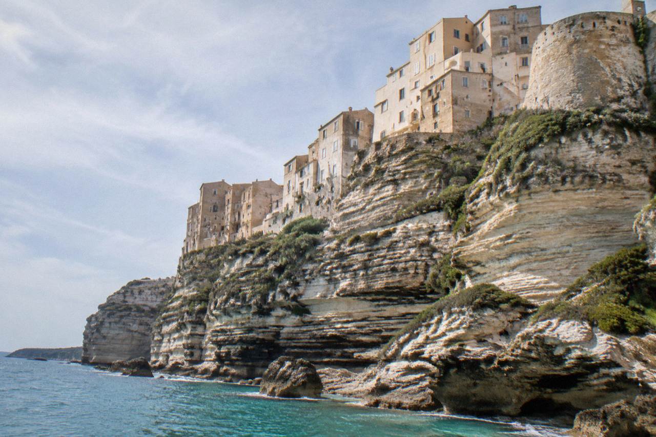 Bonifacio's old town buildings standing on white limestone cliffs above the sea