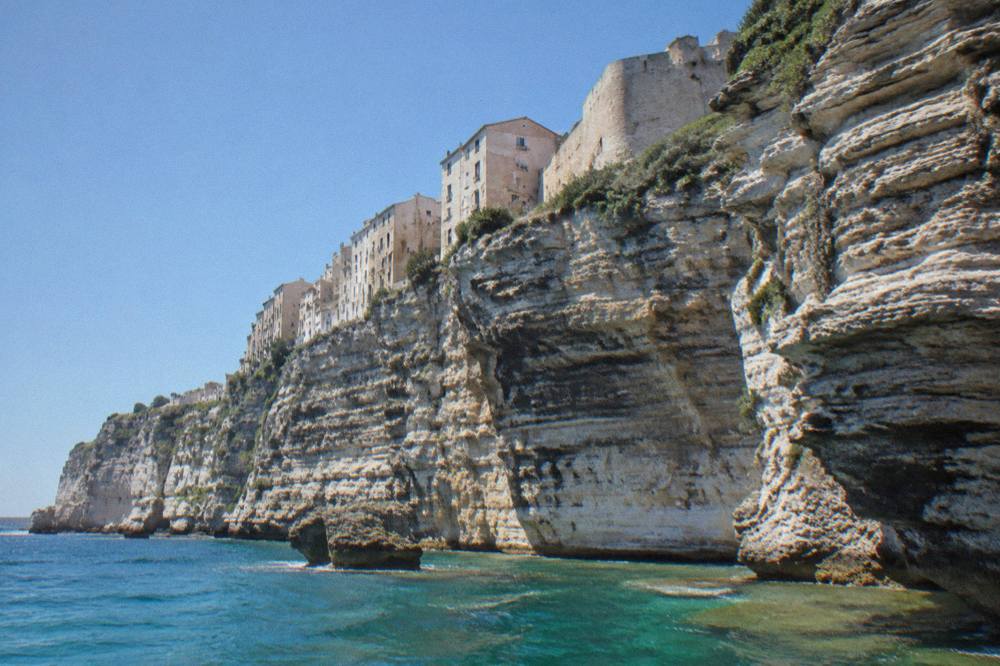 White limestone cliffs and the citadel of Bonifacio above the sea in southern Corsica