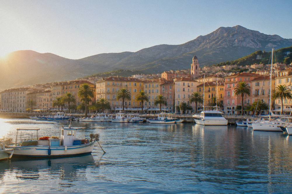Fishing boats and yachts moored in the harbour of Ajaccio along the seafront