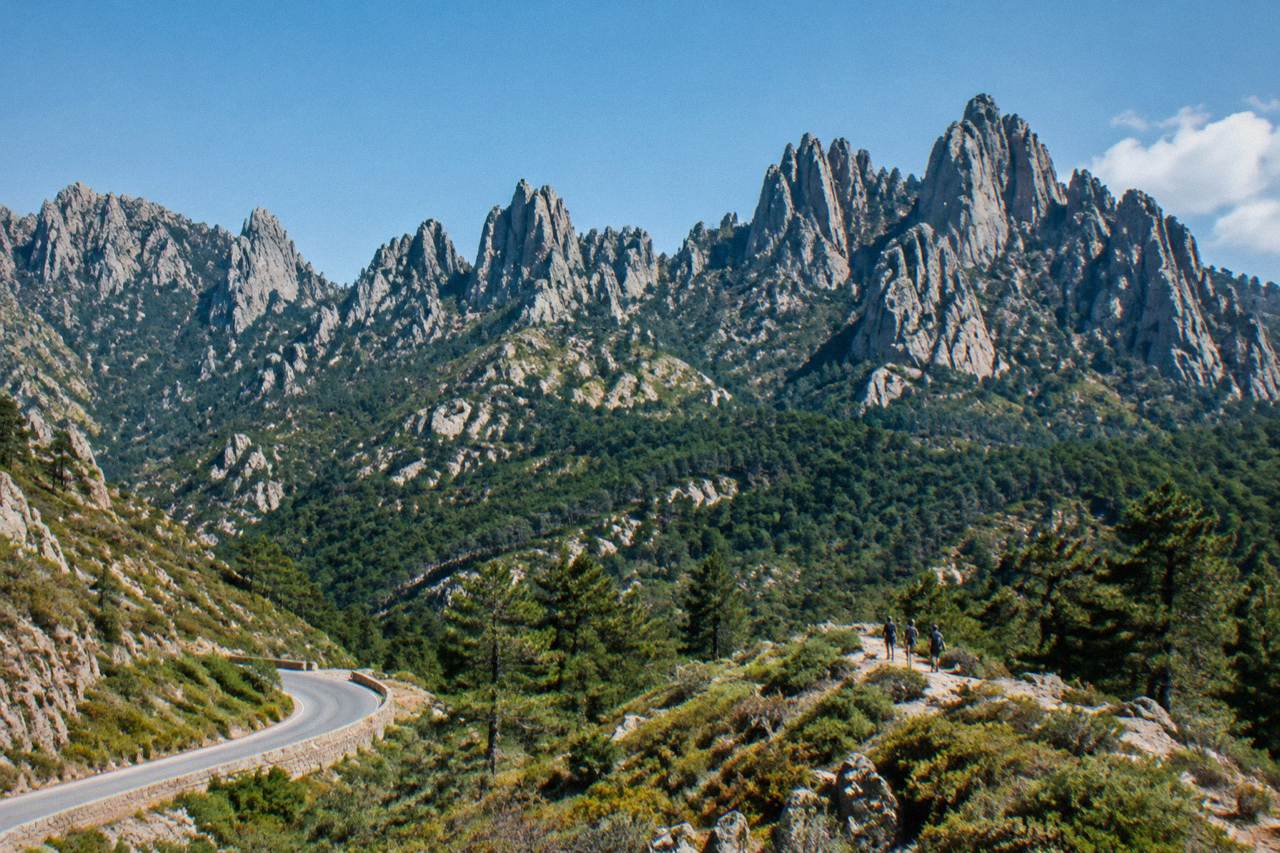 Rocky peaks of the Aiguilles de Bavella rising above pine forest in southern Corsica