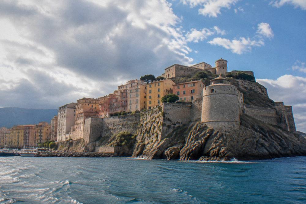 The fortified walls and towers of the Bastia citadel seen from the water
