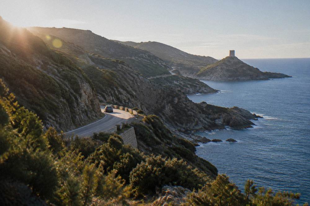 A coastal road winding along the rugged Cap Corse peninsula with the sea on one side