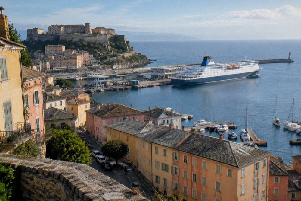 A large ferry berthed at the Bastia commercial port in morning light