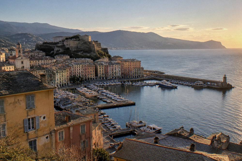 Evening light over the Bastia seafront with the mountains of Cap Corse in the distance