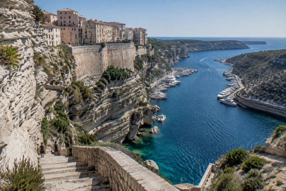 Steps cut into the cliff below Bonifacio descending towards the water of the strait