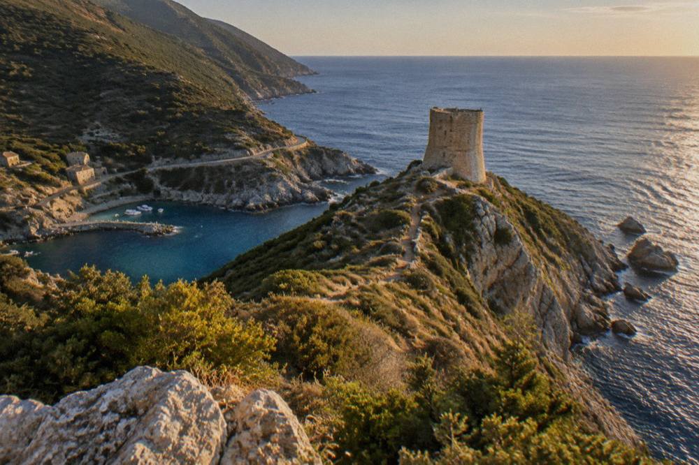 A stone watchtower on a headland above the sea in Cap Corse