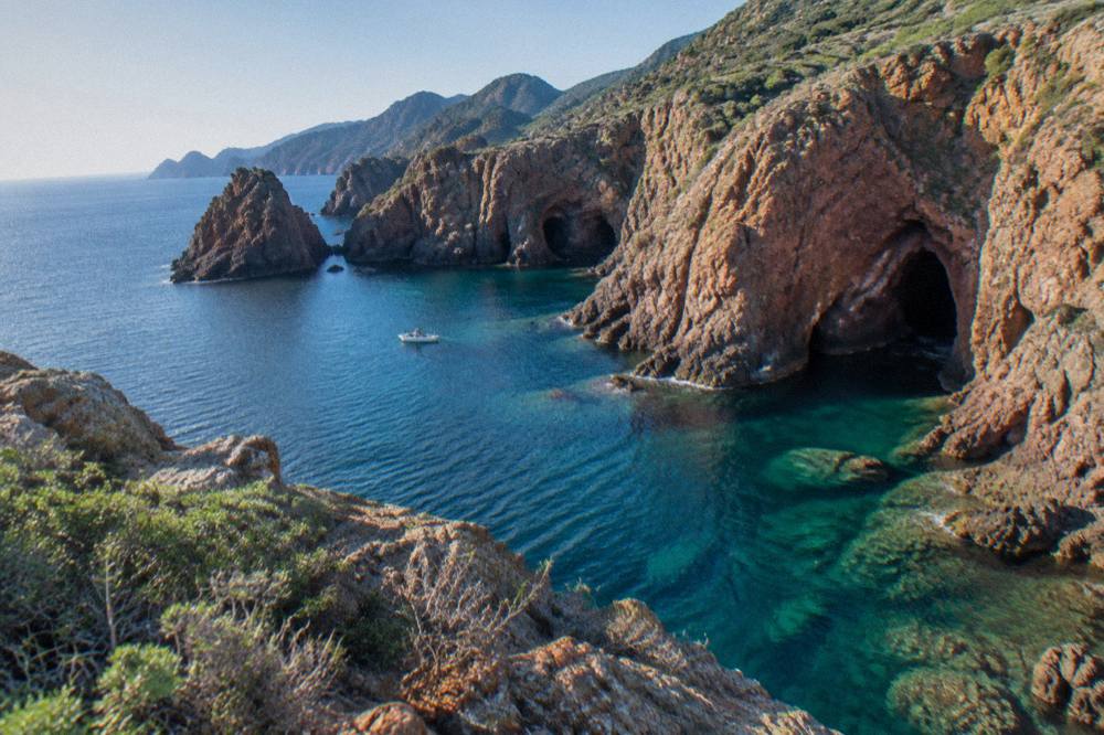A sheltered rocky cove with clear water on the Corsican north coast