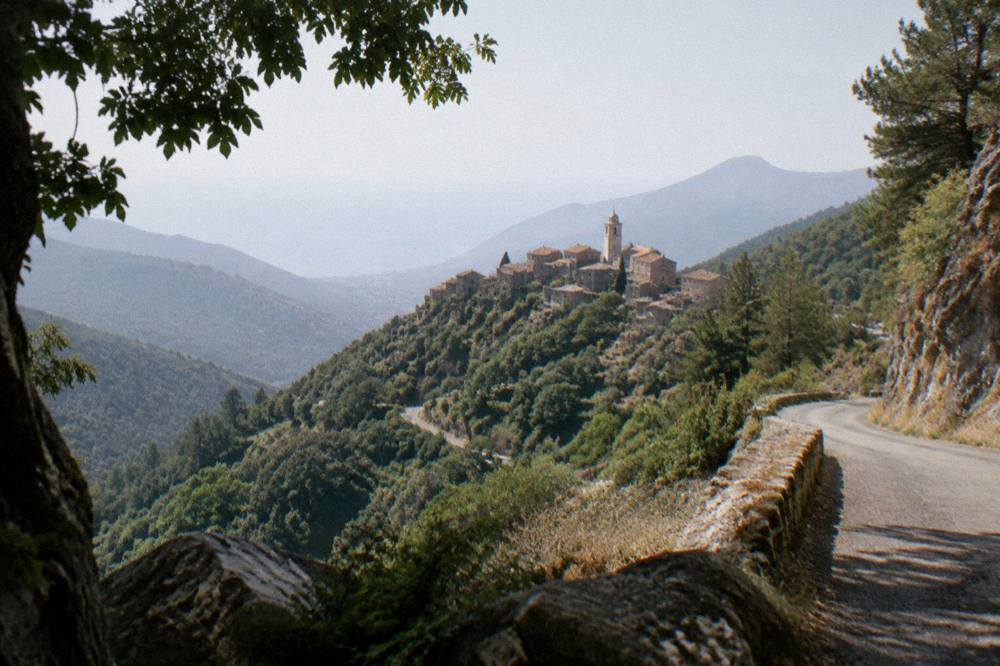 Narrow mountain road winding through maquis and rock in the Corsican interior