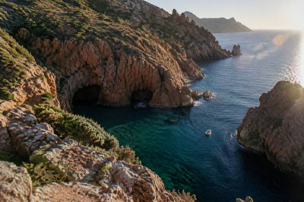 Red granite rock formations above the sea on the west coast of Corsica