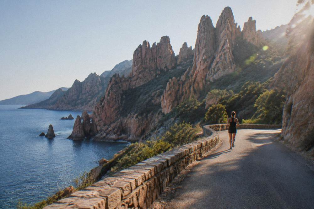 Red granite rock towers of the Calanques de Piana seen from the coast road above the sea