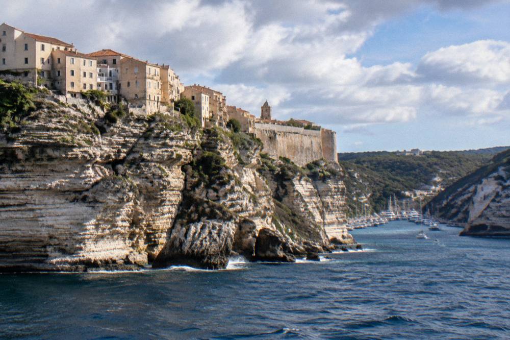 Limestone cliffs and the upper town of Bonifacio seen from the sea in southern Corsica