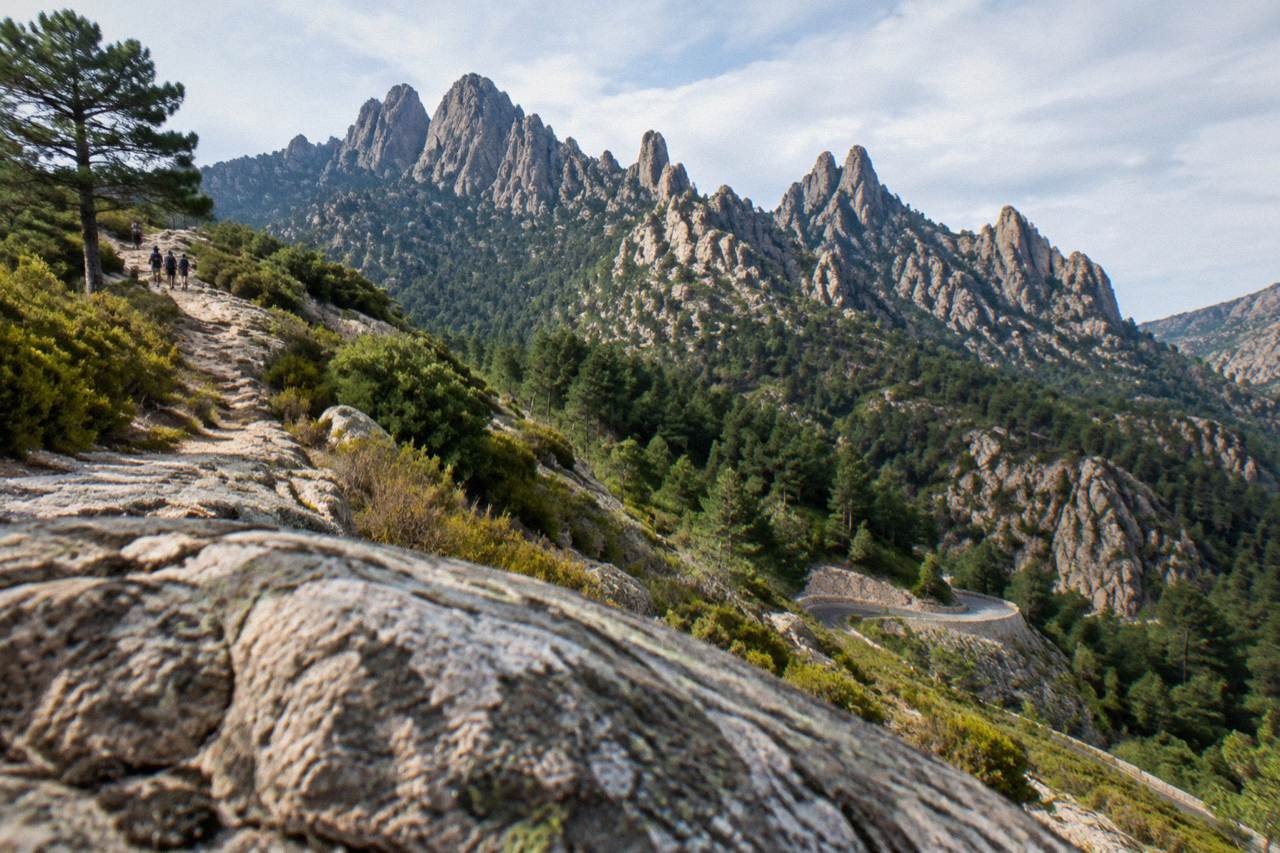 Rocky granite peaks of the Aiguilles de Bavella rising above pine forest in southern Corsica