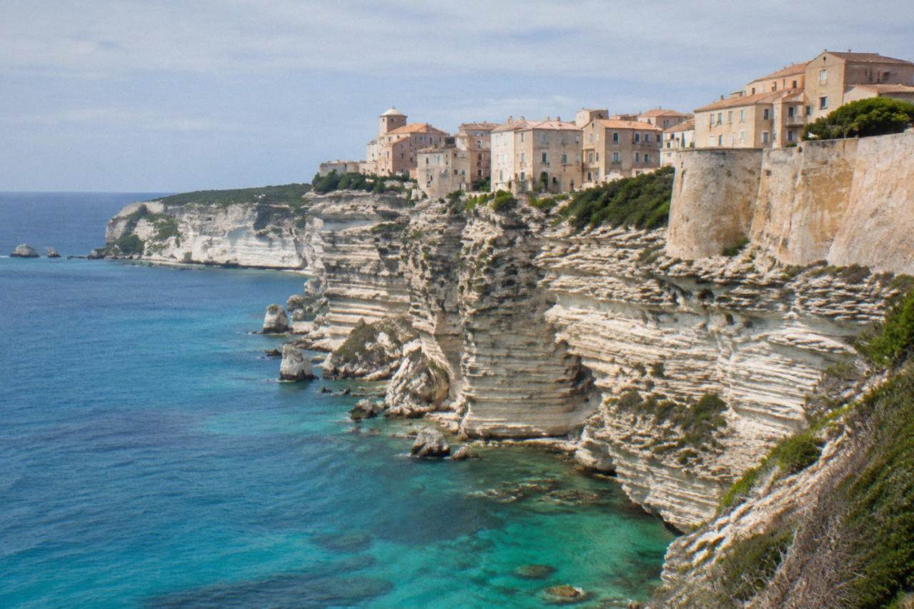 The tall white cliffs of Bonifacio rising above the sea with the town's walls on top