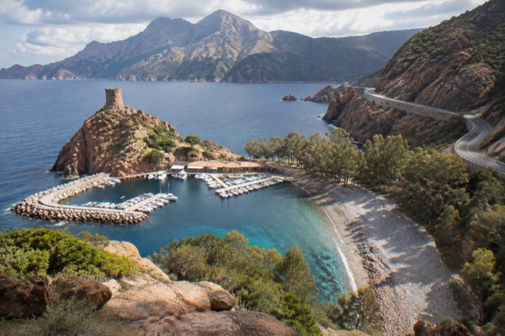 A coast road winding along the cliffs between Porto and Piana in Corsica