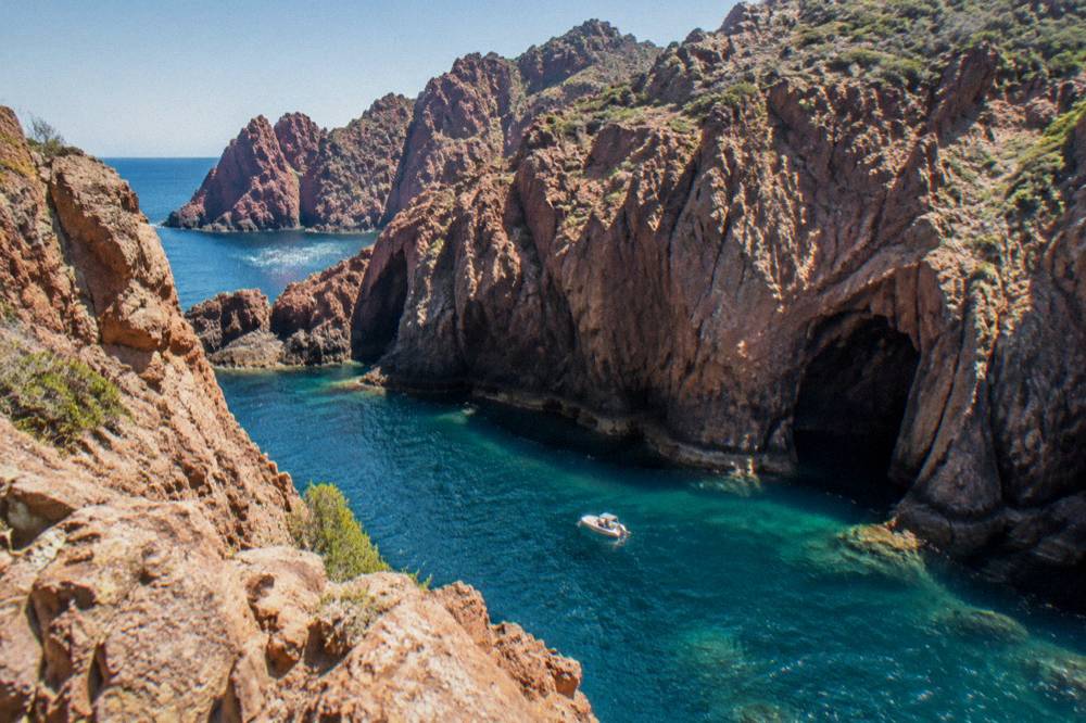 Red granite rock formations along the shoreline of the Scandola reserve in Corsica
