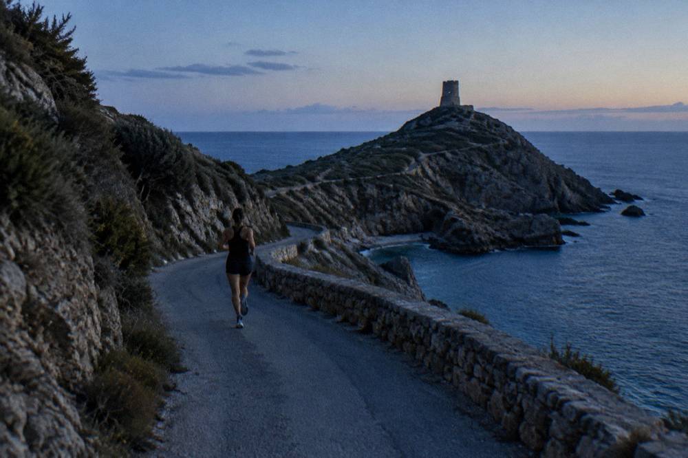 Rocky Cap Corse headland with a watchtower silhouette against the open sea