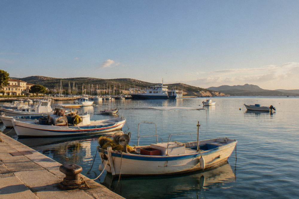 Fishing boats and calm clear water in a small Corsican harbour at midday
