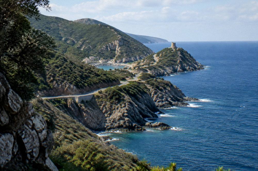 Coastal road and headlands of Cap Corse seen from above the sea