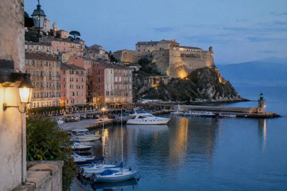 Evening light on the citadel walls of Bastia with calm sea in the harbour