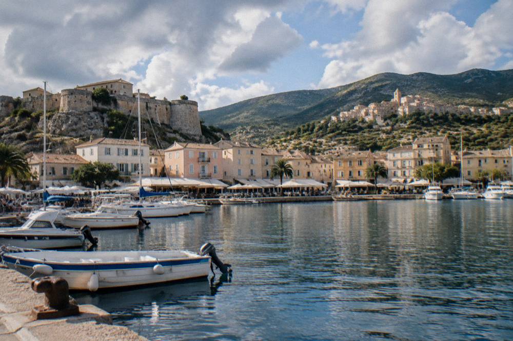 A hilltop stone village above green slopes in the Balagne region of Corsica