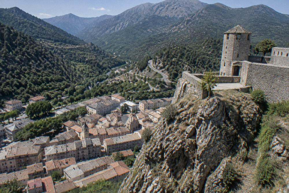 Mountain road winding through forested hills toward Corte in central Corsica