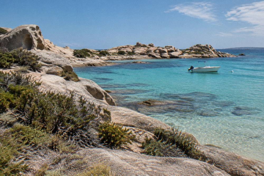 Low granite slabs and wind-shaped rocks under an open sky on Lavezzi island