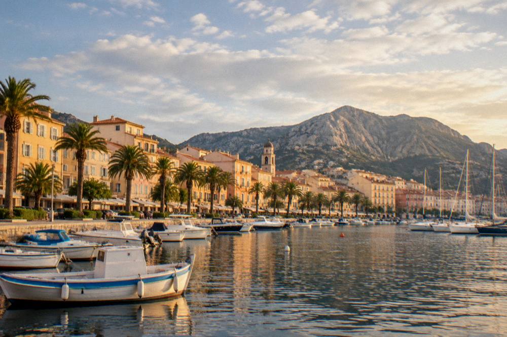 The Ajaccio seafront at golden hour with boats in the bay