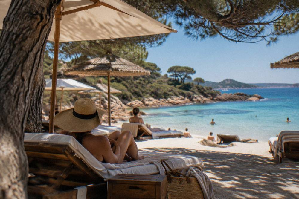 Sun loungers and parasols on the sand at Palombaggia in summer