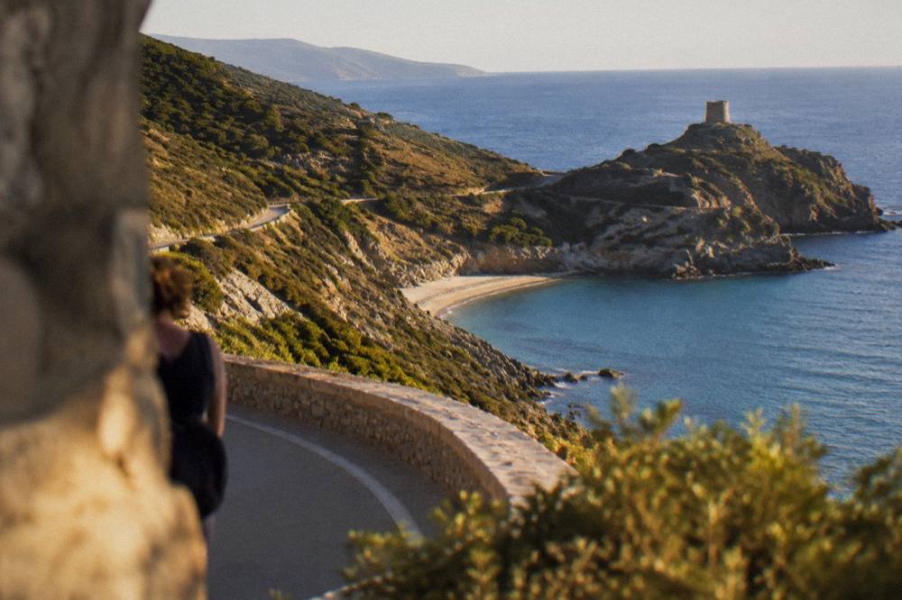 Coastal road view above a sandy bay in southeast Corsica