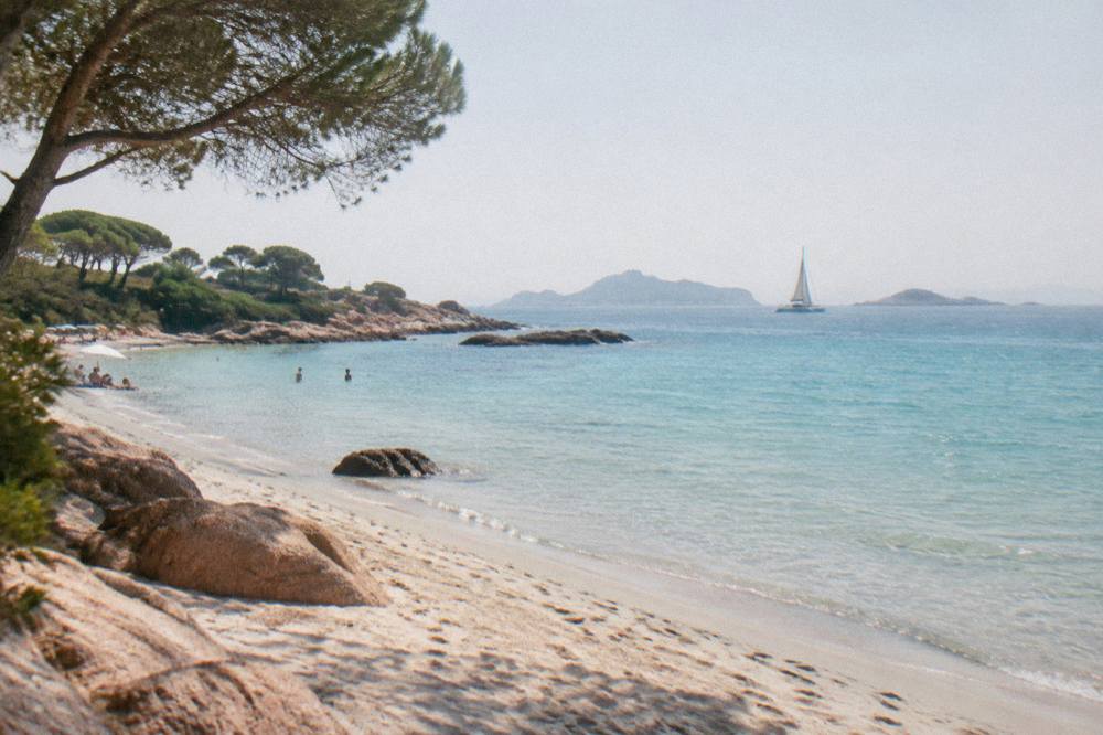Catamaran sailing toward islands on the horizon off southern Corsica