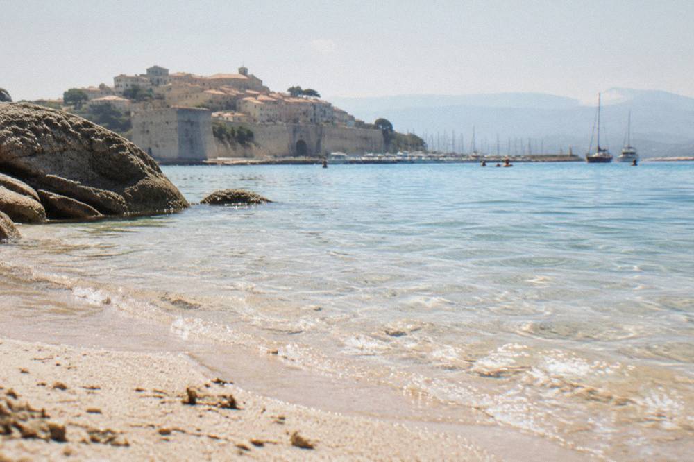 Sand and shallow gulf water at a beach on Corsica's south-east coast near Porto-Vecchio.