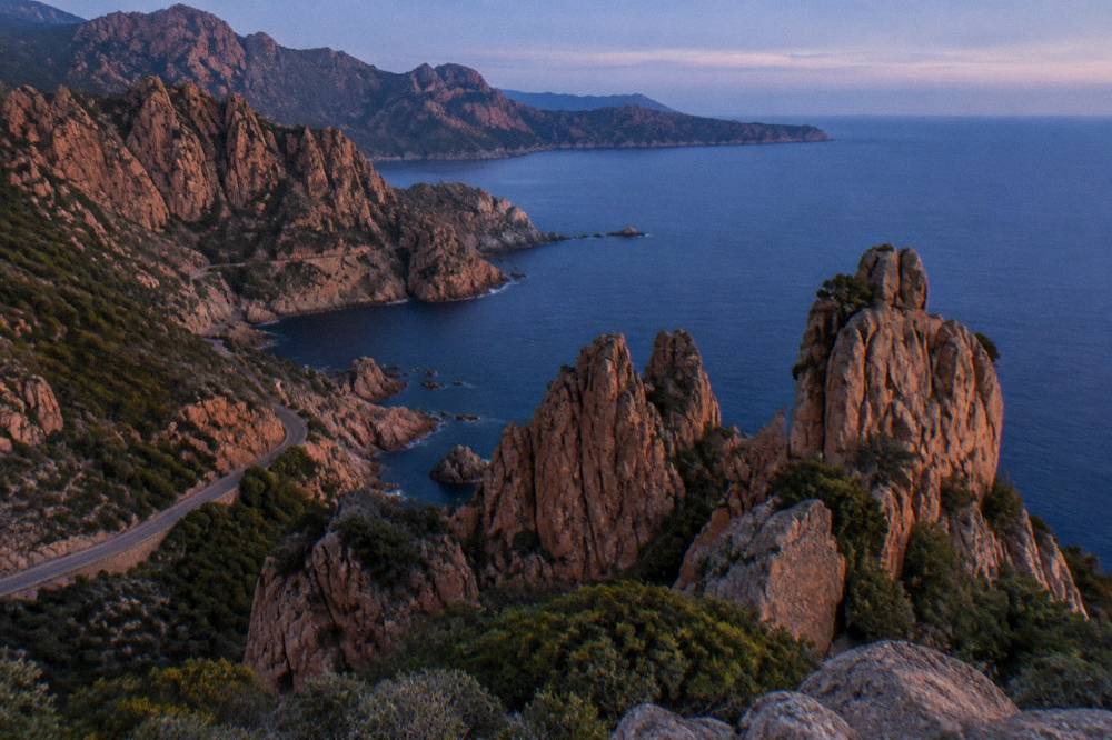 Rocky red pinnacles above the sea near Piana in evening light