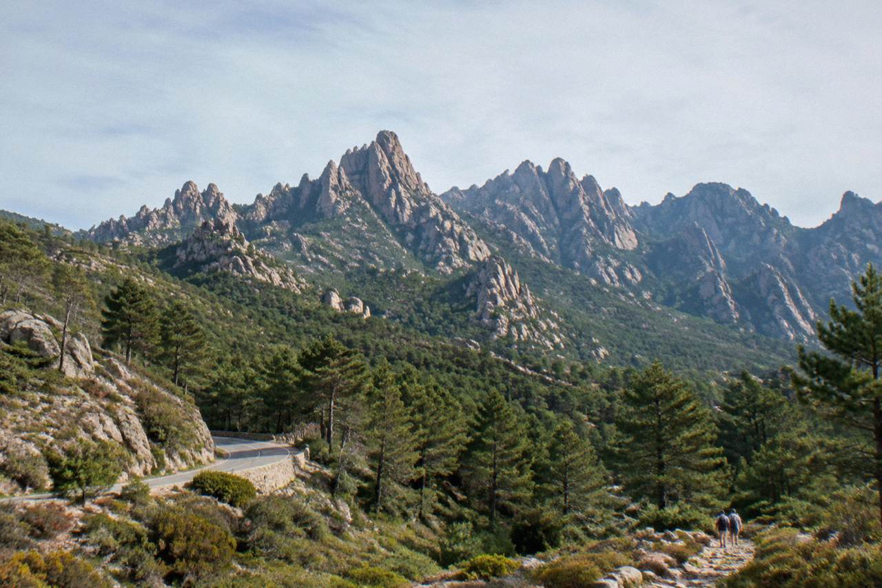 Rocky granite peaks of the Aiguilles de Bavella rising above pine forest in southern Corsica