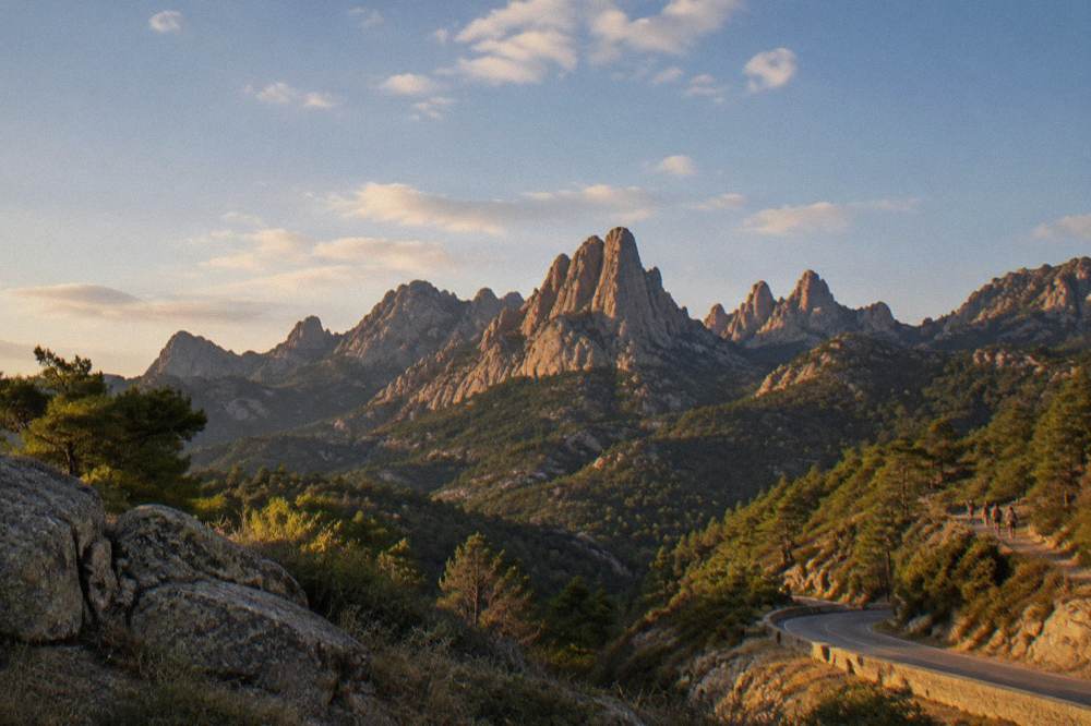 Granite rock needles of the Bavella massif under a clear blue sky with scattered clouds