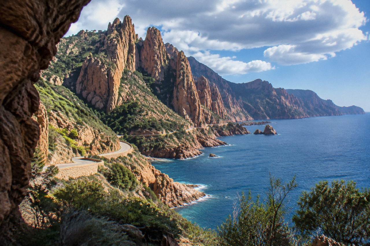 Red granite cliffs of the Calanques de Piana rising above the sea on the west coast of Corsica