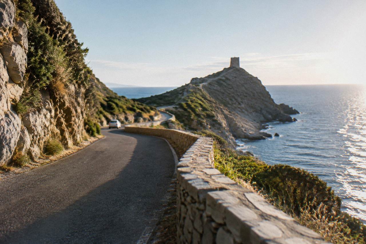 A coastal road winding along the rocky northern tip of Cap Corse with the sea on one side