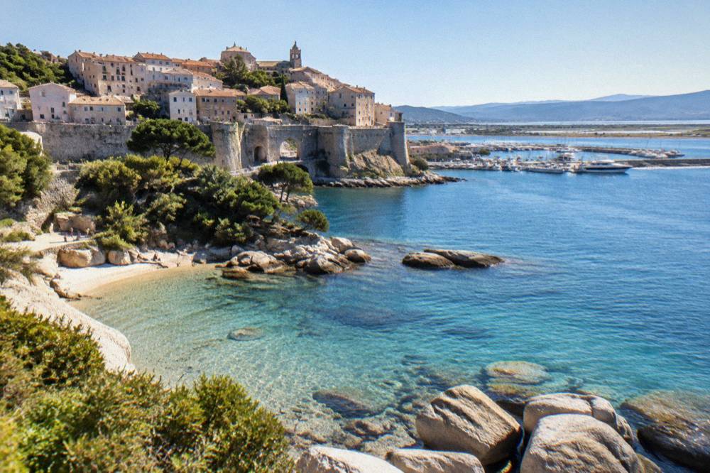 Granite boulders and shallow clear water on a small island beach