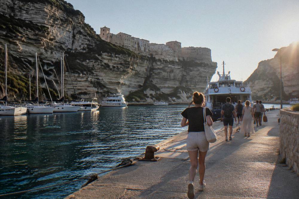 A quay with passengers walking toward a moored ferry