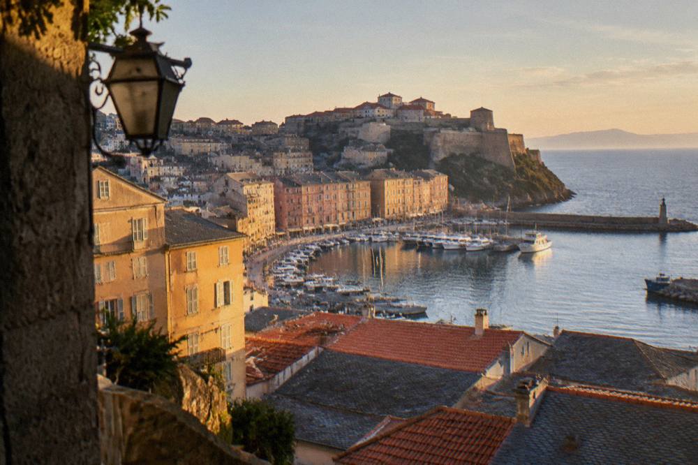 View over red-roofed Bastia houses and the old harbor with moored boats