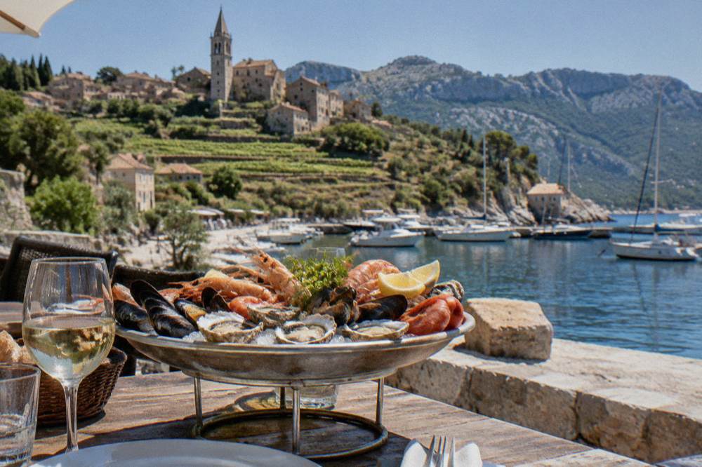 A seafood platter on a restaurant table beside a marina