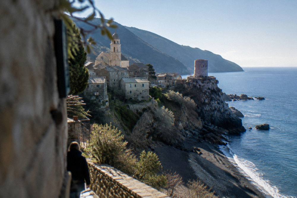 A hilltop Corsican village with stone houses and a church tower