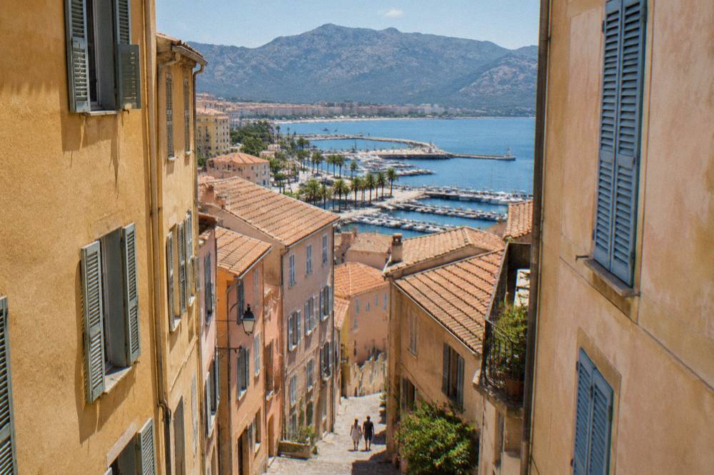 A narrow old-town street in Ajaccio with tall shuttered houses