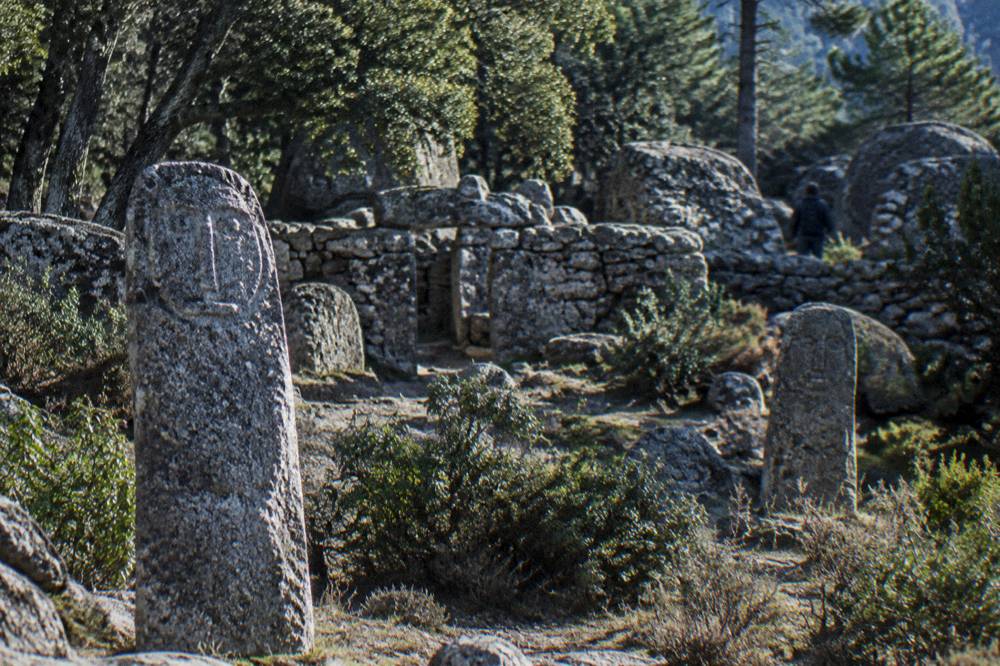 Granite standing stones with carved faces at a prehistoric site in southern Corsica