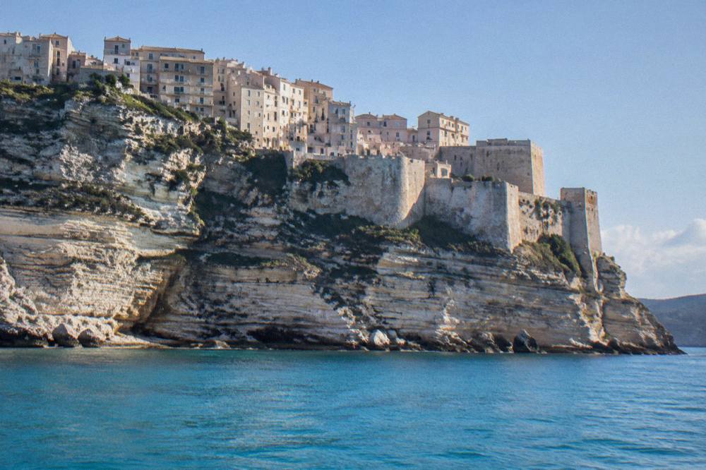 The cliff-top town of Bonifacio seen from the water with the citadel walls above