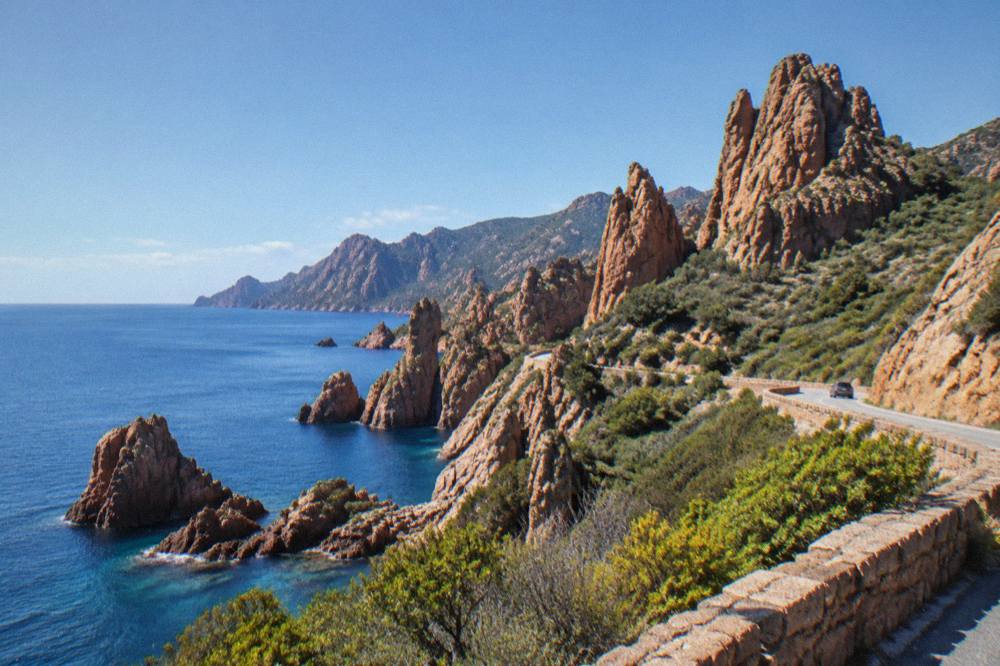 Red granite rock formations of the Calanques de Piana above the sea road