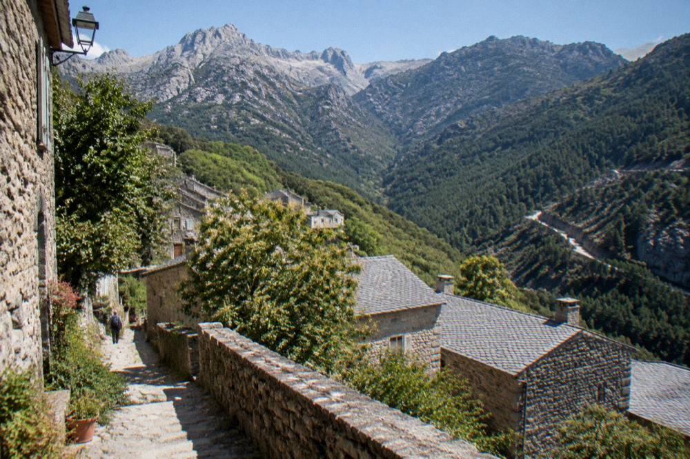 White limestone peaks above a forested mountain road in southern Corsica