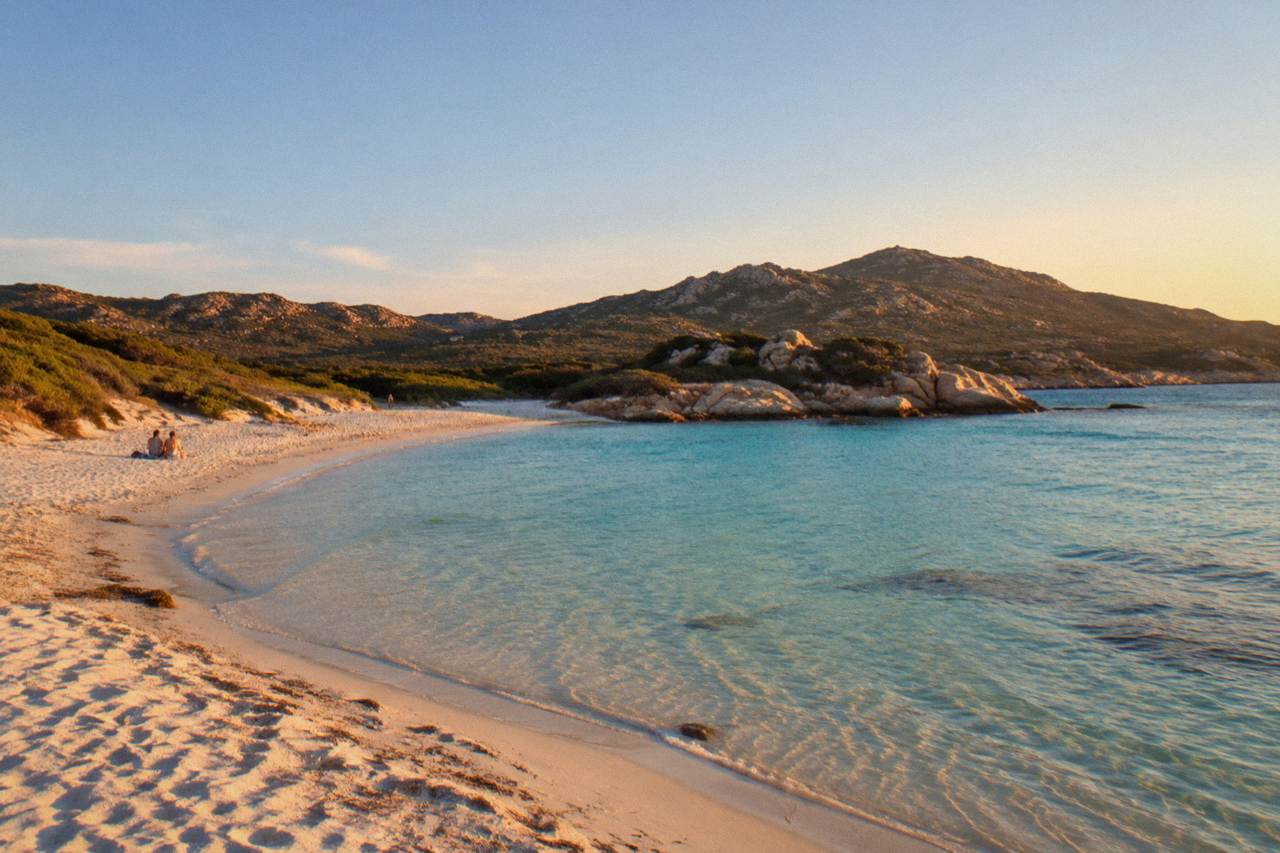 A quiet cove with clear water and granite rocks on the Corsican coast