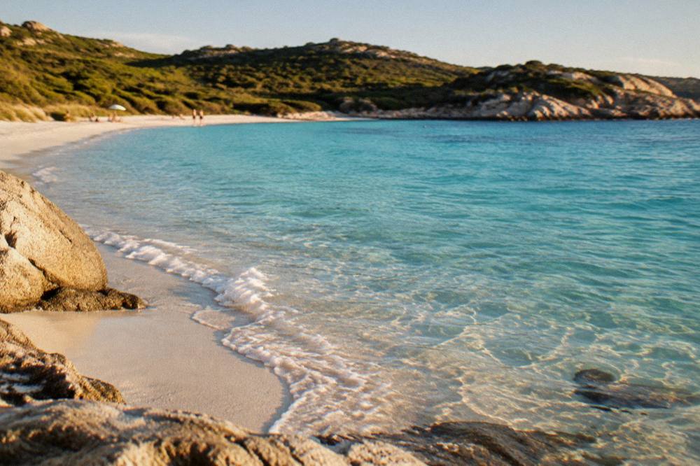 Turquoise water washing the white sand of a southern Corsican beach
