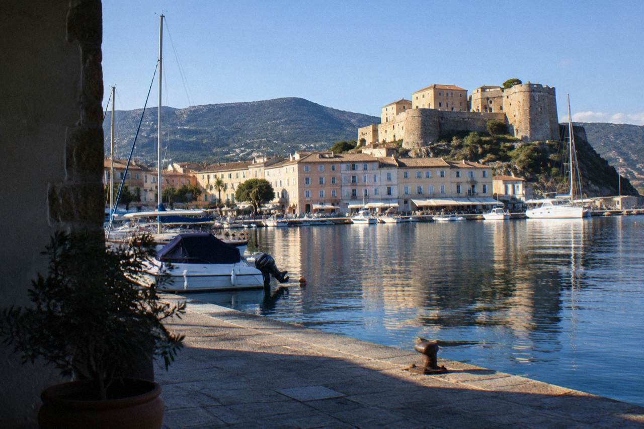 The harbour of Saint-Florent on the northern coast of Corsica with boats moored along the quay